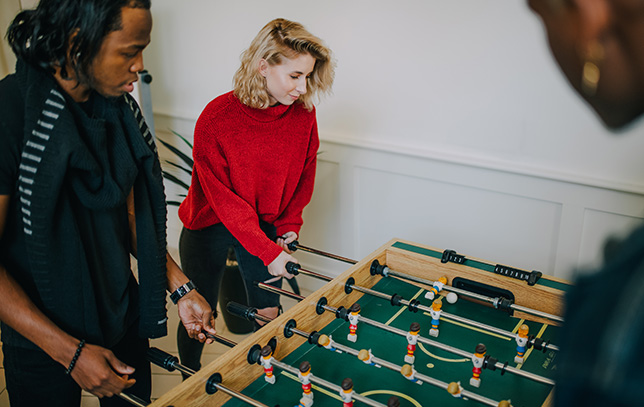 Group of patients playing foosball