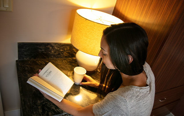 patient reading a book at a desk as a coping mechanism