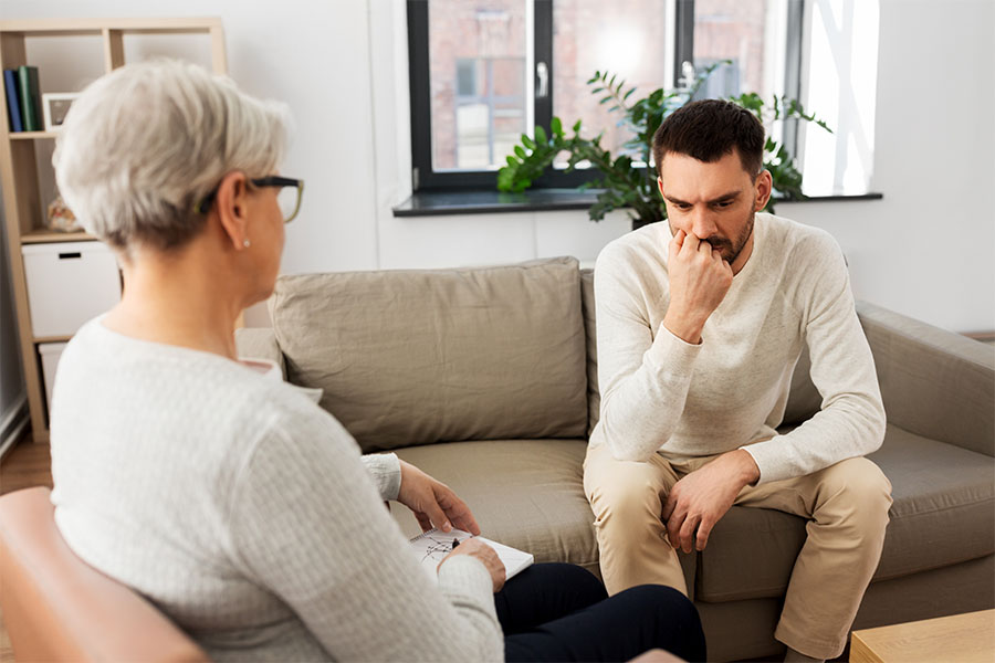 Therapist woman chatting with a man patient